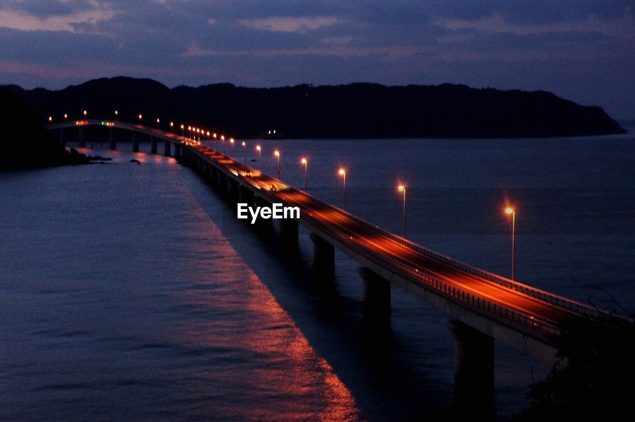 LIGHT TRAILS ON BRIDGE AT NIGHT