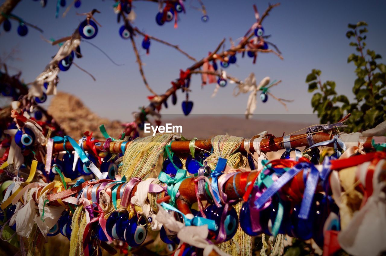 Low angle view of decorations hanging on tree against sky