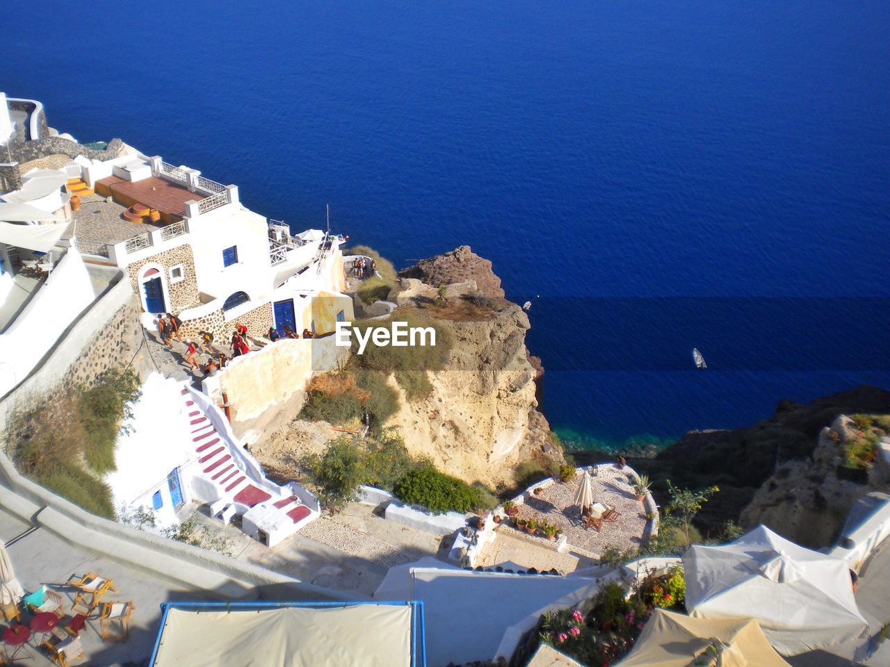 High angle view of people in town by aegean sea at santorini