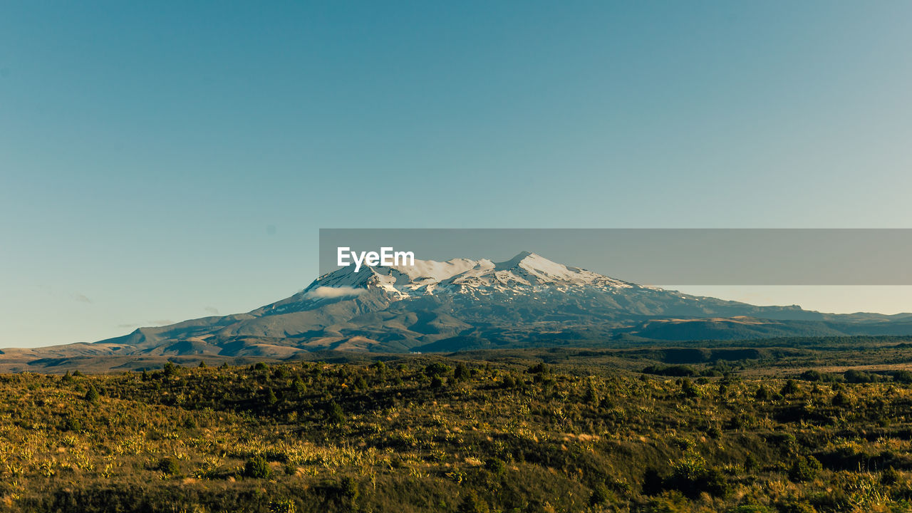 Scenic view of mountains against clear blue sky