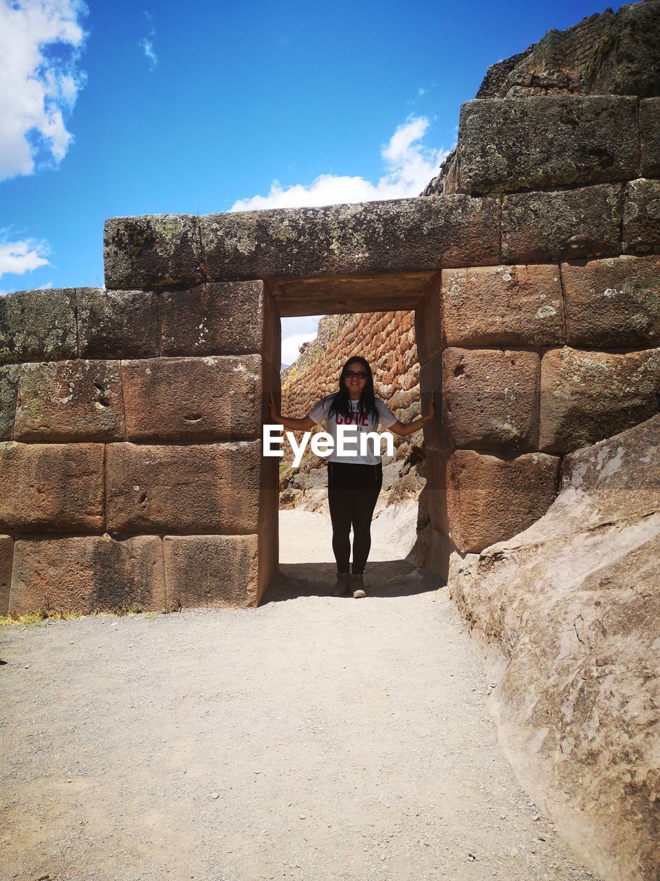 WOMAN STANDING AGAINST WALL