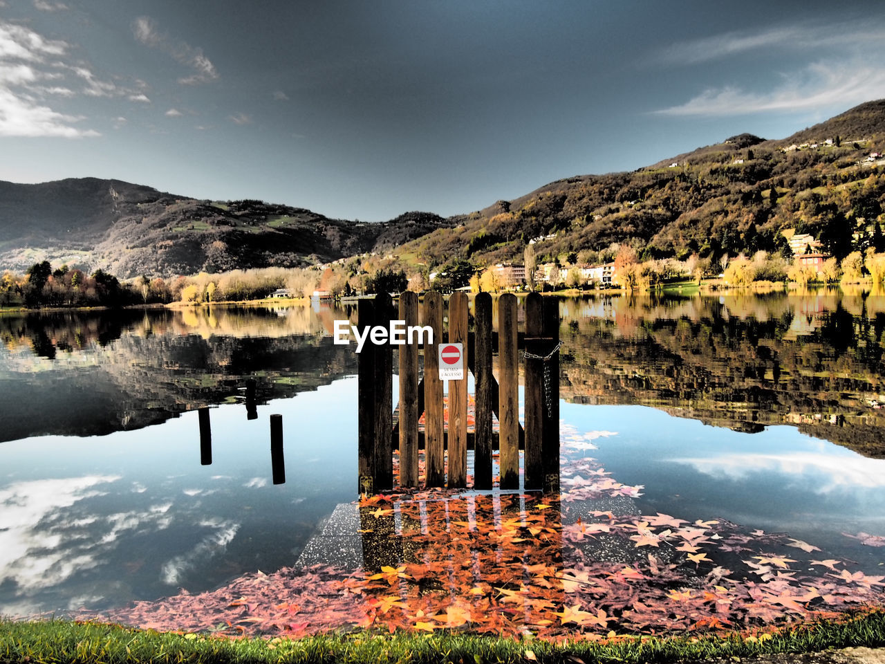 Scenic view of lake by mountains against sky