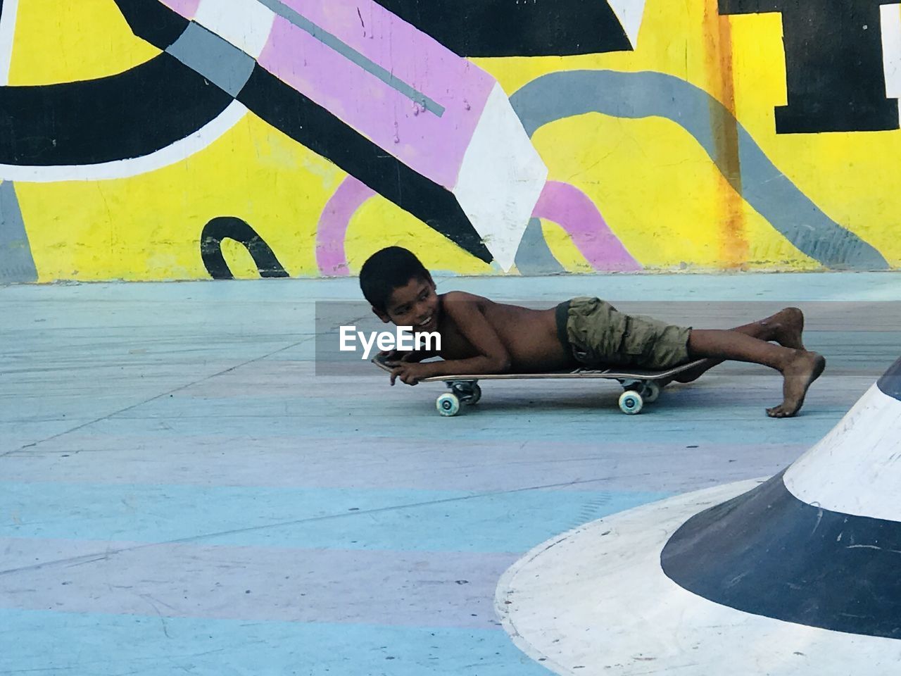 YOUNG MAN SKATEBOARDING ON SKATEBOARD