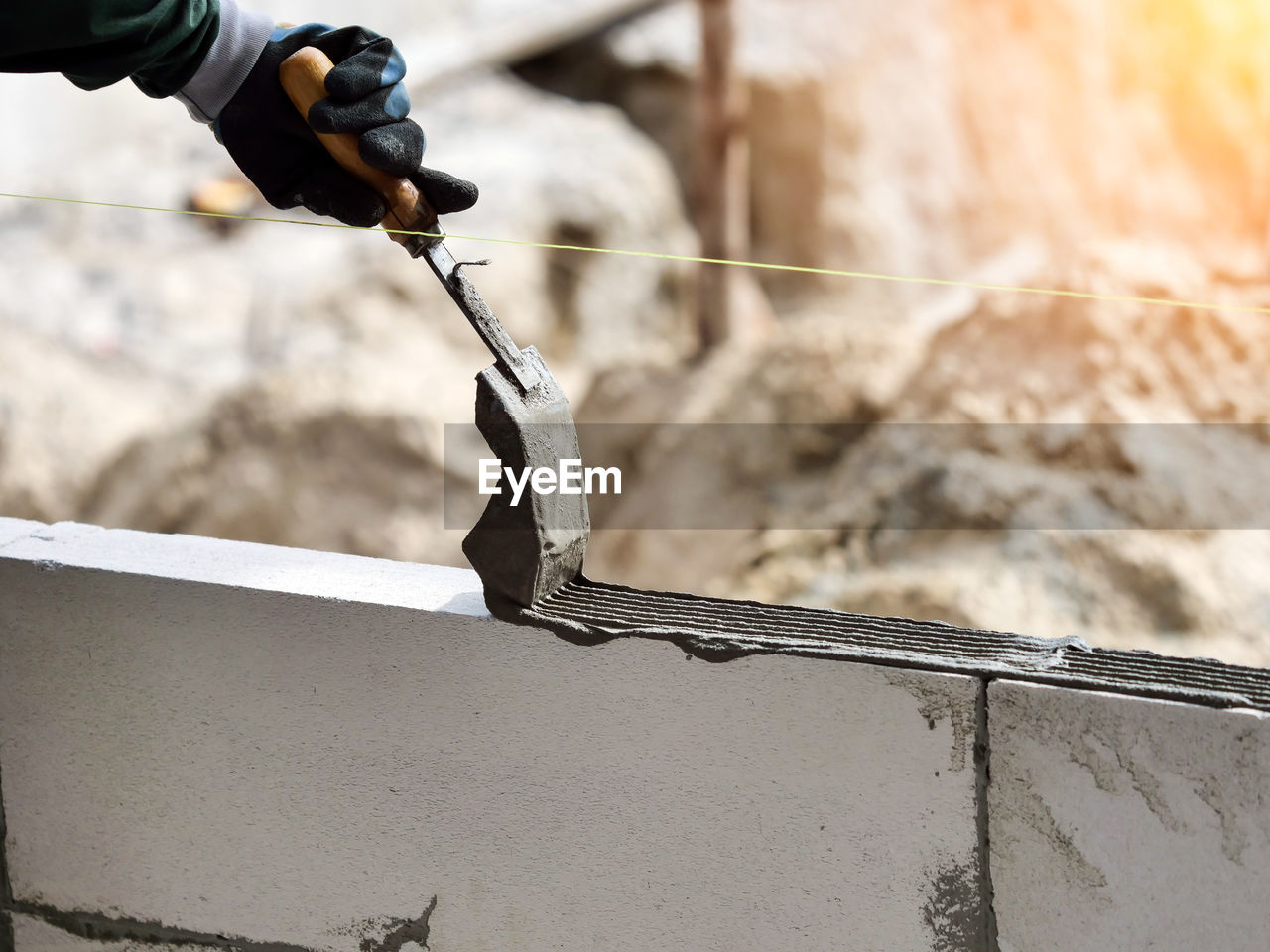 Bricklayer industrial worker installing brick masonry cement