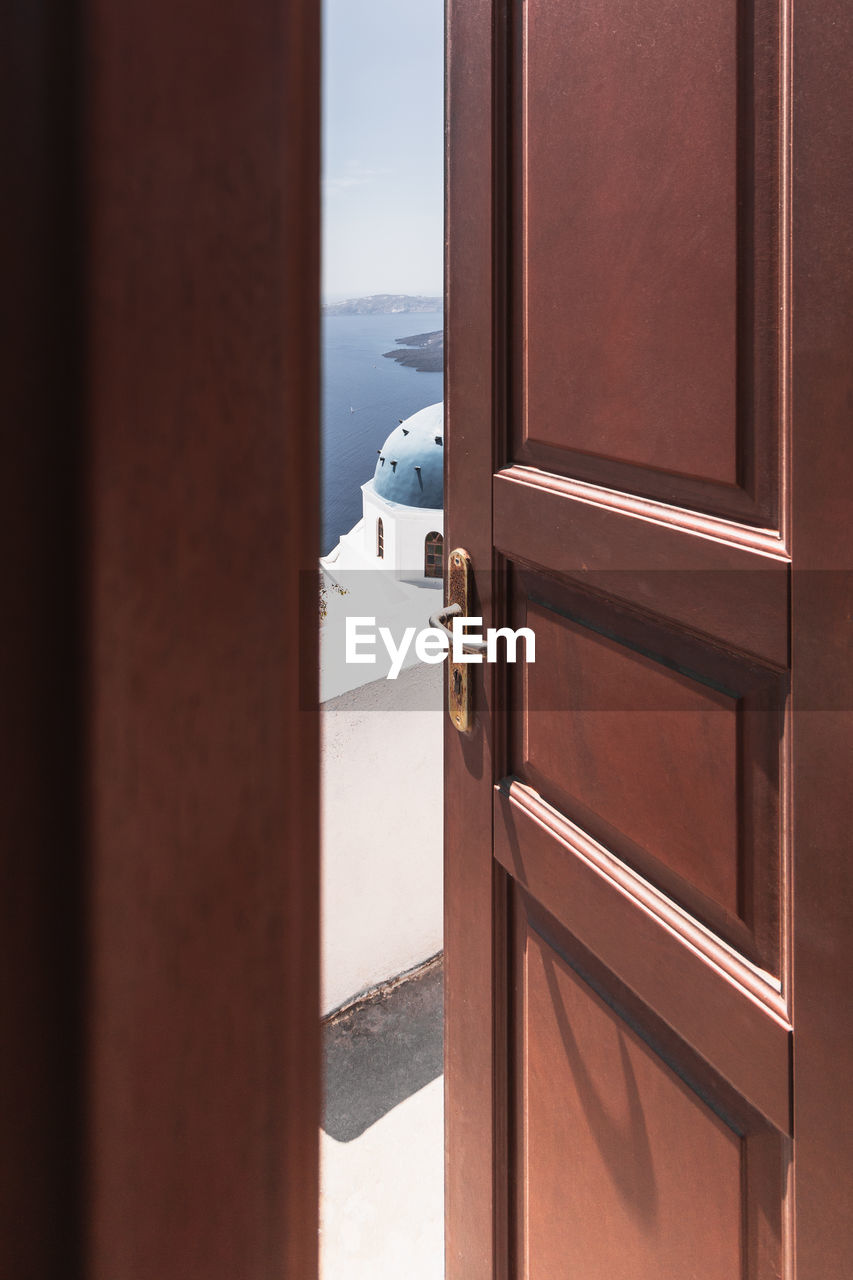 Open wooden door in santorini, greece, cyclades