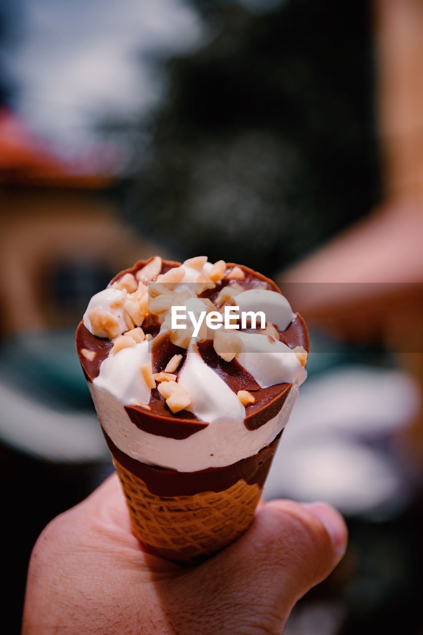 Close-up of hand holding ice cream