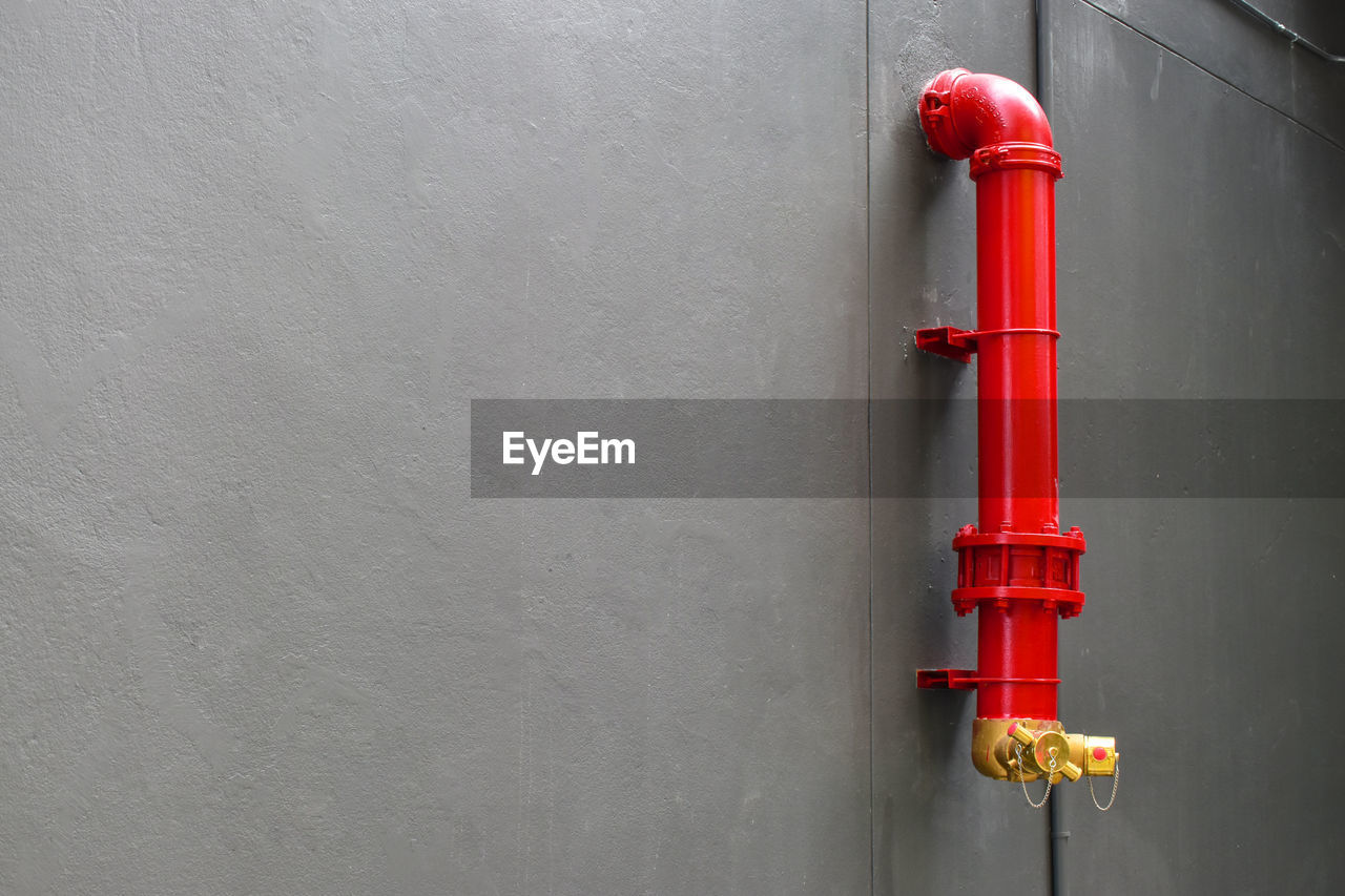 RED PIPE ON WALL