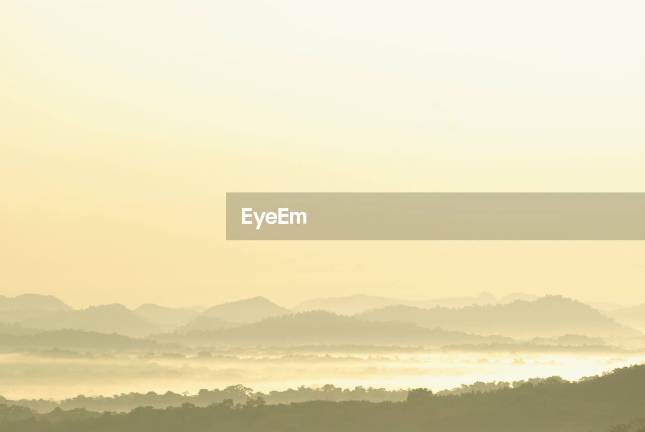 Scenic view of silhouette mountains against sky during sunset