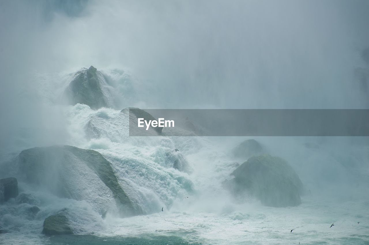 SCENIC VIEW OF WATERFALL IN SEA