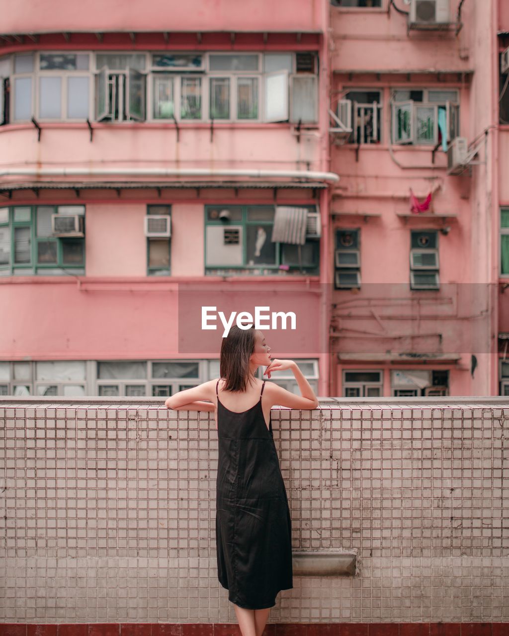 Rear view of woman standing in balcony