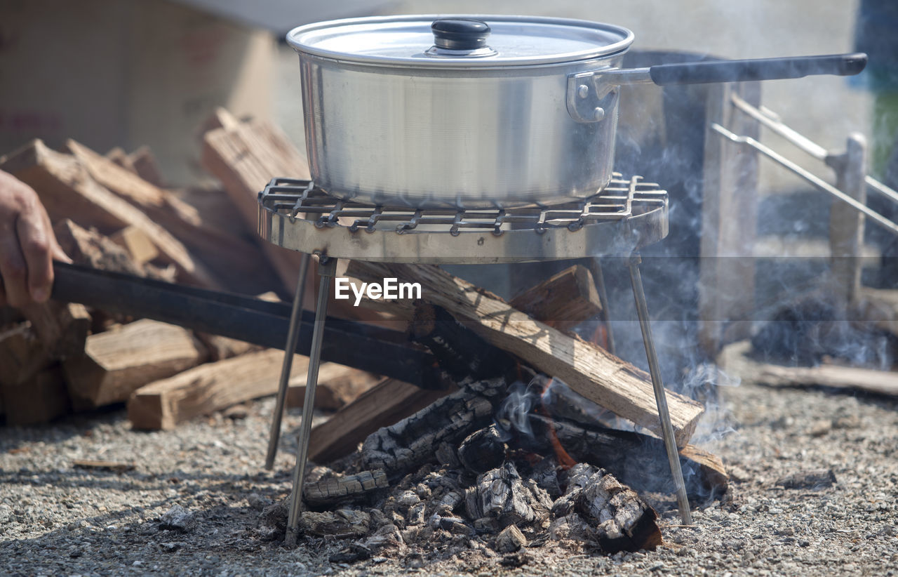 Cropped image of person cooking at campsite