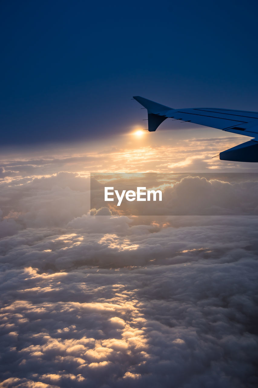 AERIAL VIEW OF AIRCRAFT WING AGAINST SKY