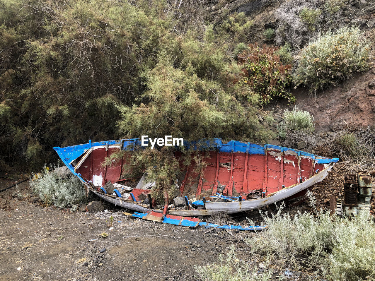 Abandoned boats moored on shore