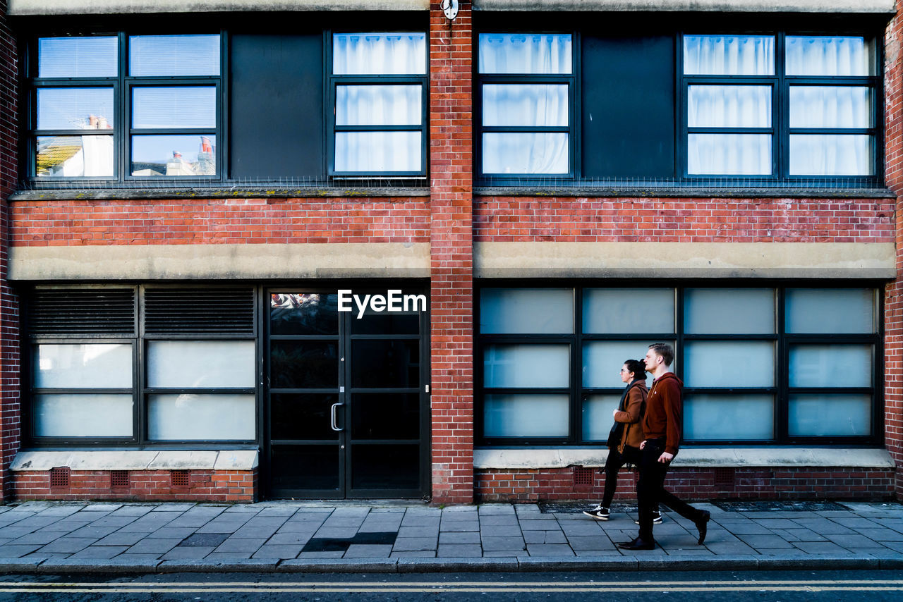 WOMAN STANDING OUTSIDE WINDOW