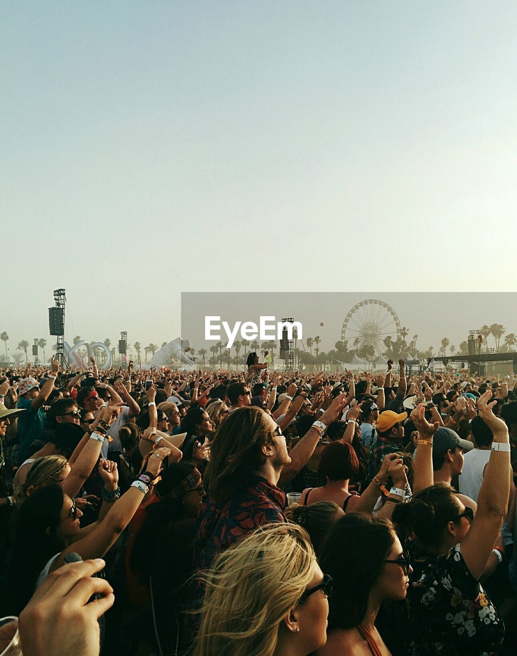 People enjoying at concert against clear sky