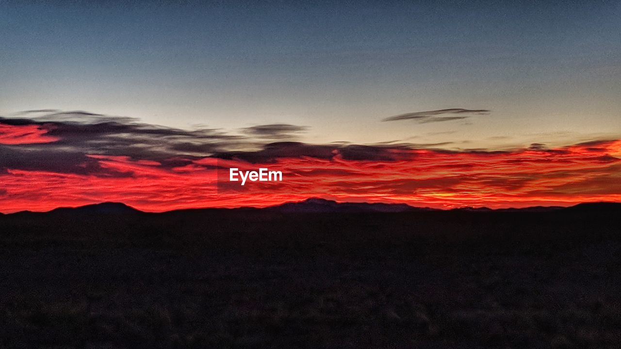 SILHOUETTE LANDSCAPE AGAINST SKY DURING SUNSET