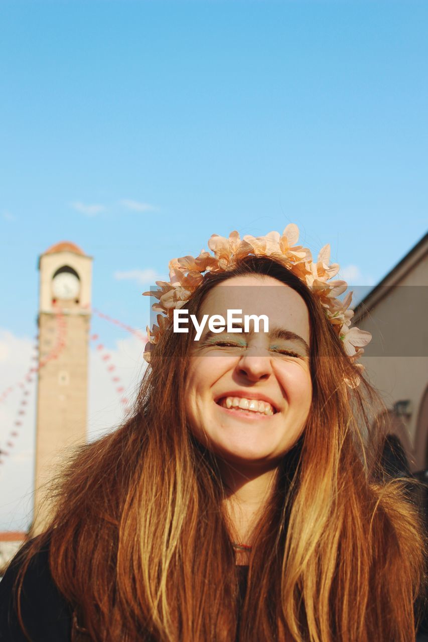 Portrait of young woman smiling behind historic old clock tower adana turkey 