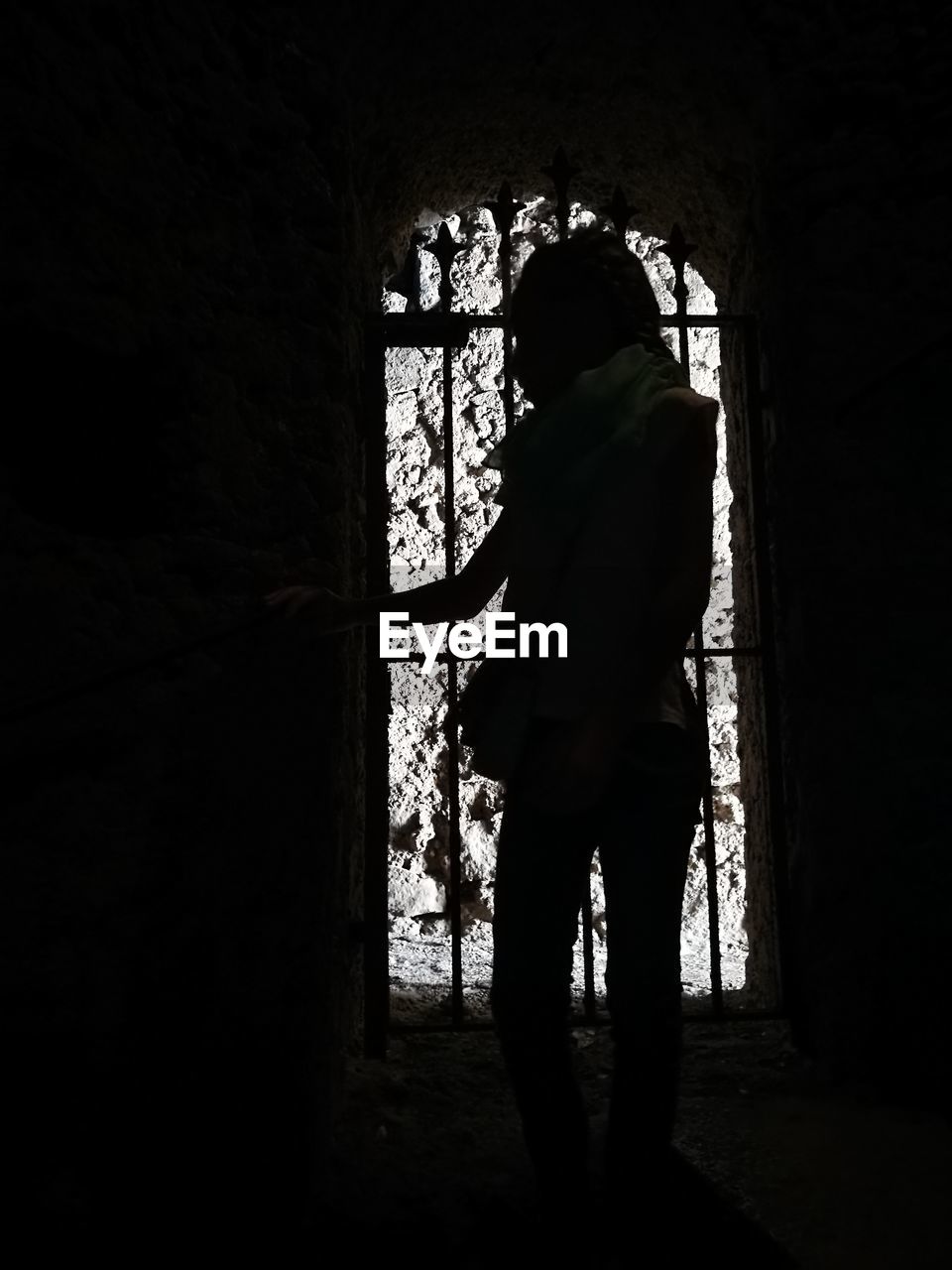 SILHOUETTE OF MAN WITH ARMS