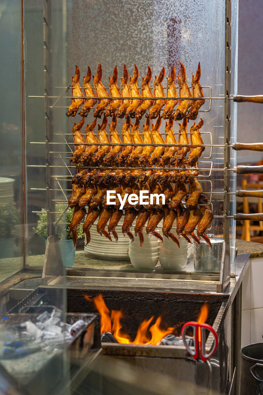 Roasted chicken wings on fire coals in chinese restaurant