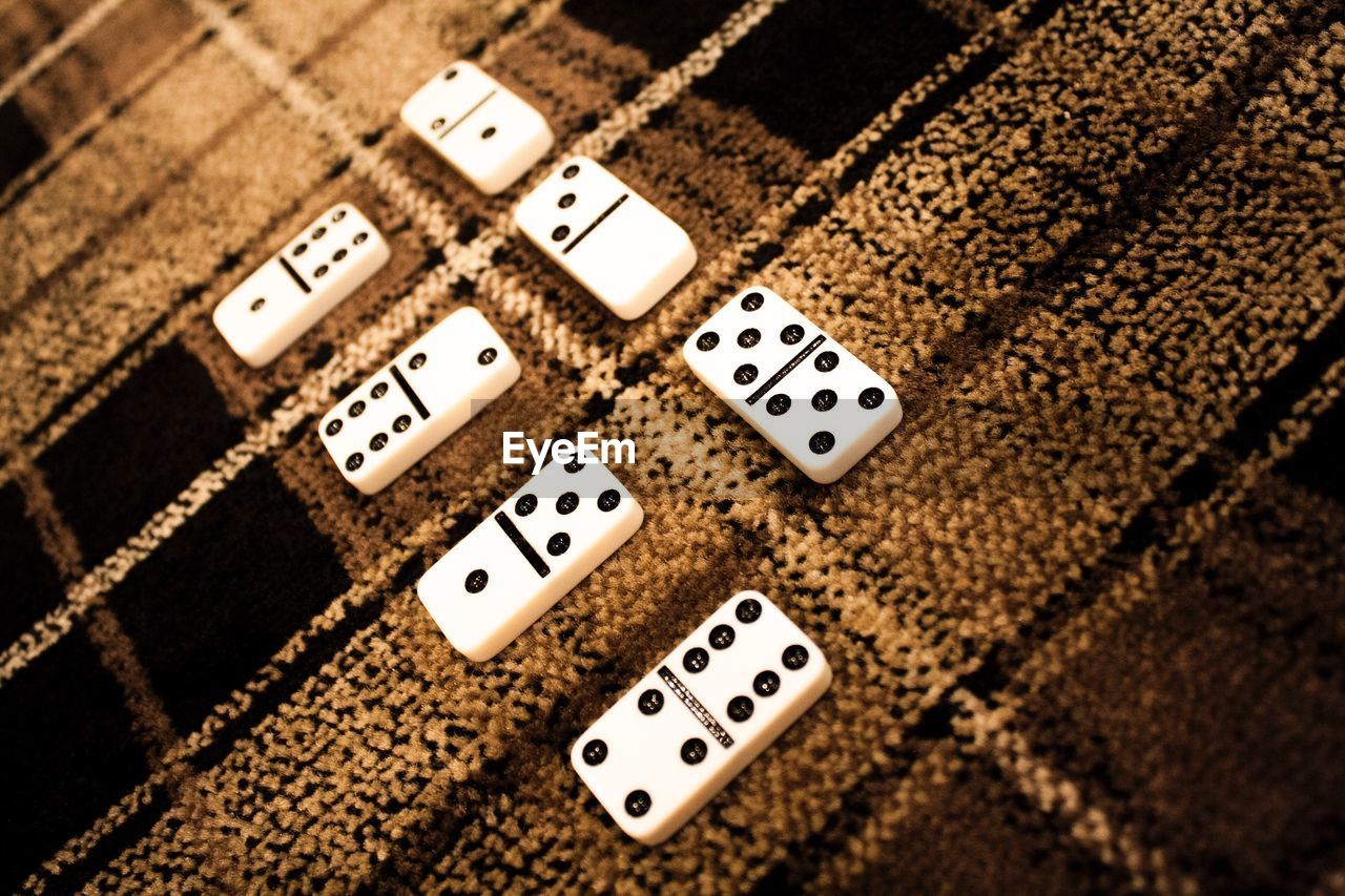 High angle view of dominos on carpet at home