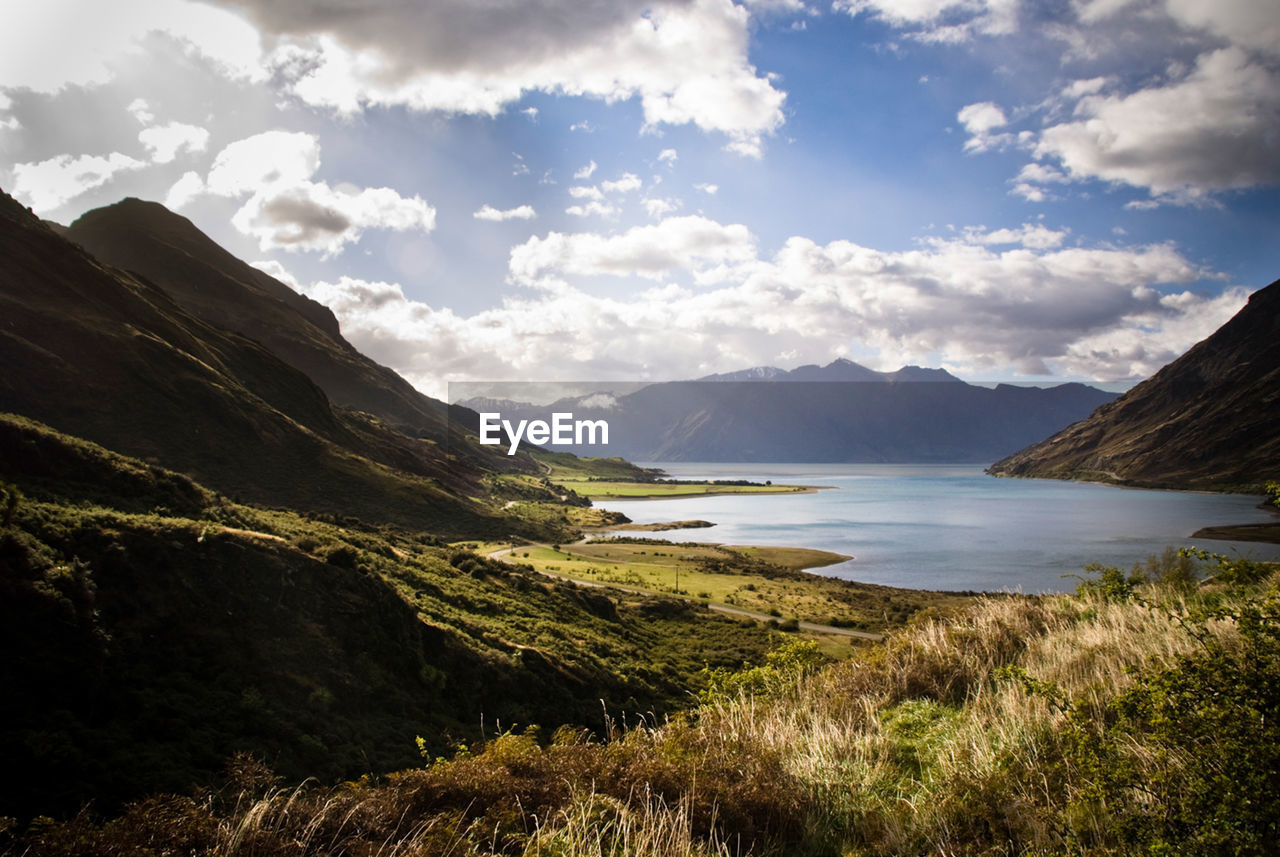 SCENIC VIEW OF LANDSCAPE AND MOUNTAINS AGAINST SKY