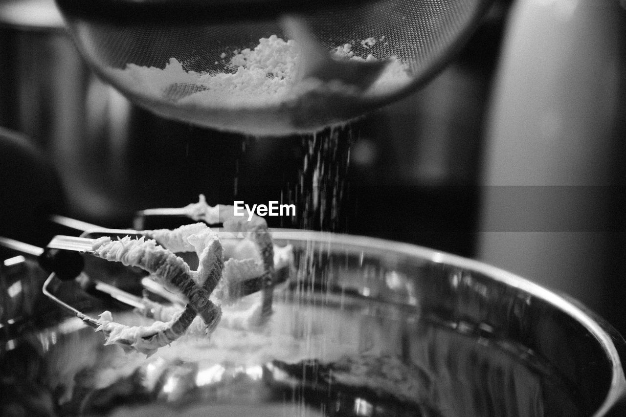 Close-up of flour and hand mixer