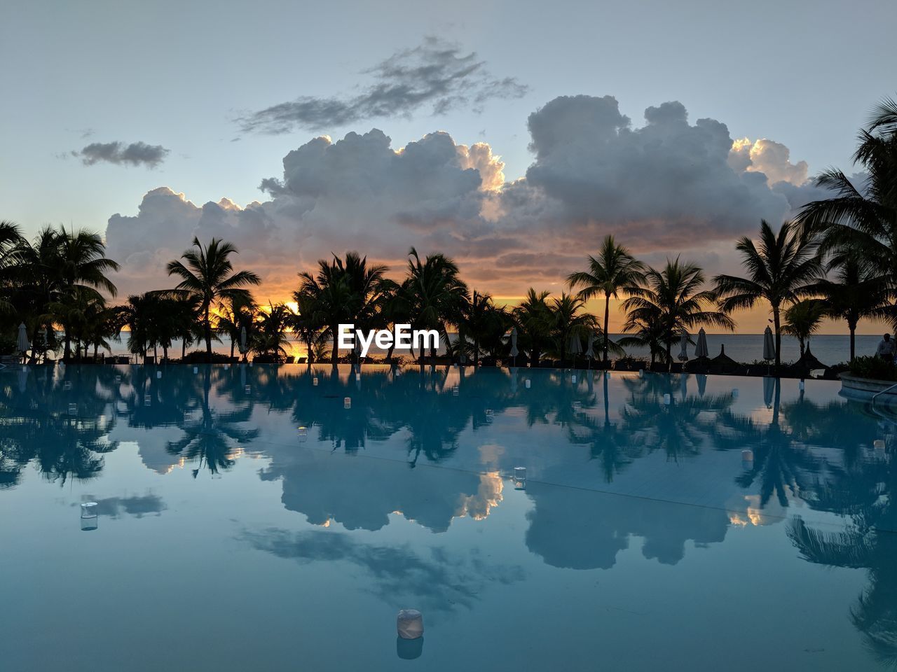 Scenic view of swimming pool against sky during sunset