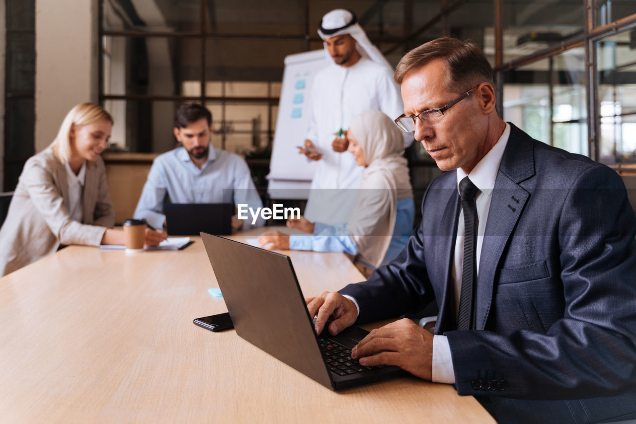 business colleagues working at desk in office