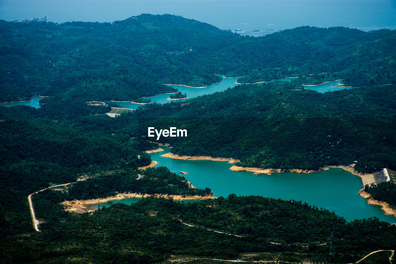 High angle view of lake and trees against sky