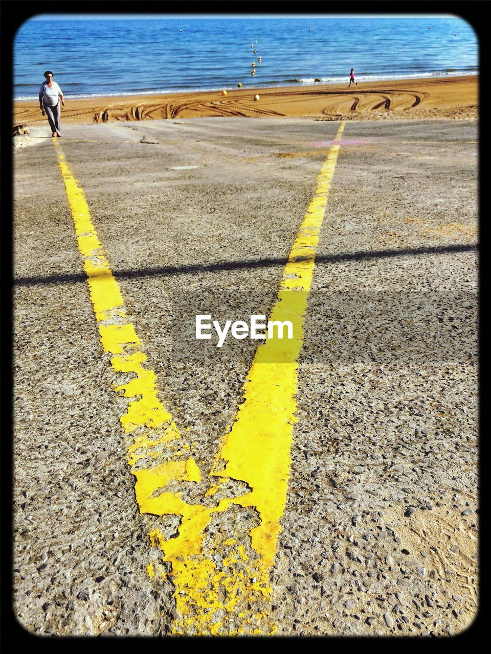 yellow, road marking, marking, road, sign, symbol, transportation, transfer print, day, auto post production filter, water, nature, guidance, asphalt, outdoors, communication, beach, high angle view, road sign, city, double yellow line, street, sea, sunlight, no people, land