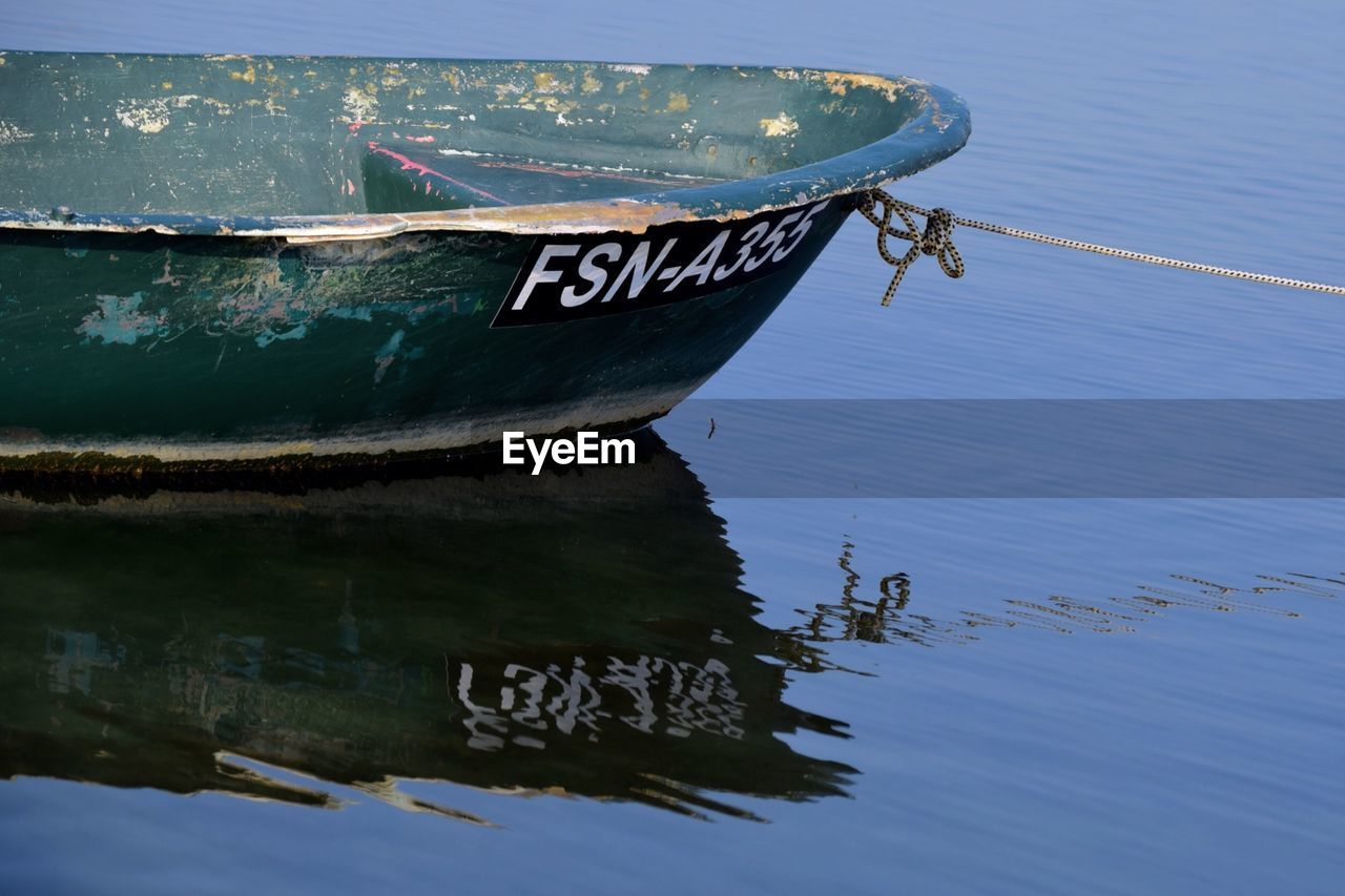 CLOSE-UP OF NAUTICAL VESSEL MOORED AT SHORE