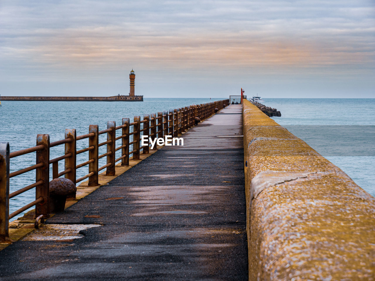 View from the pier towards lighthouse guarding harbour entrance