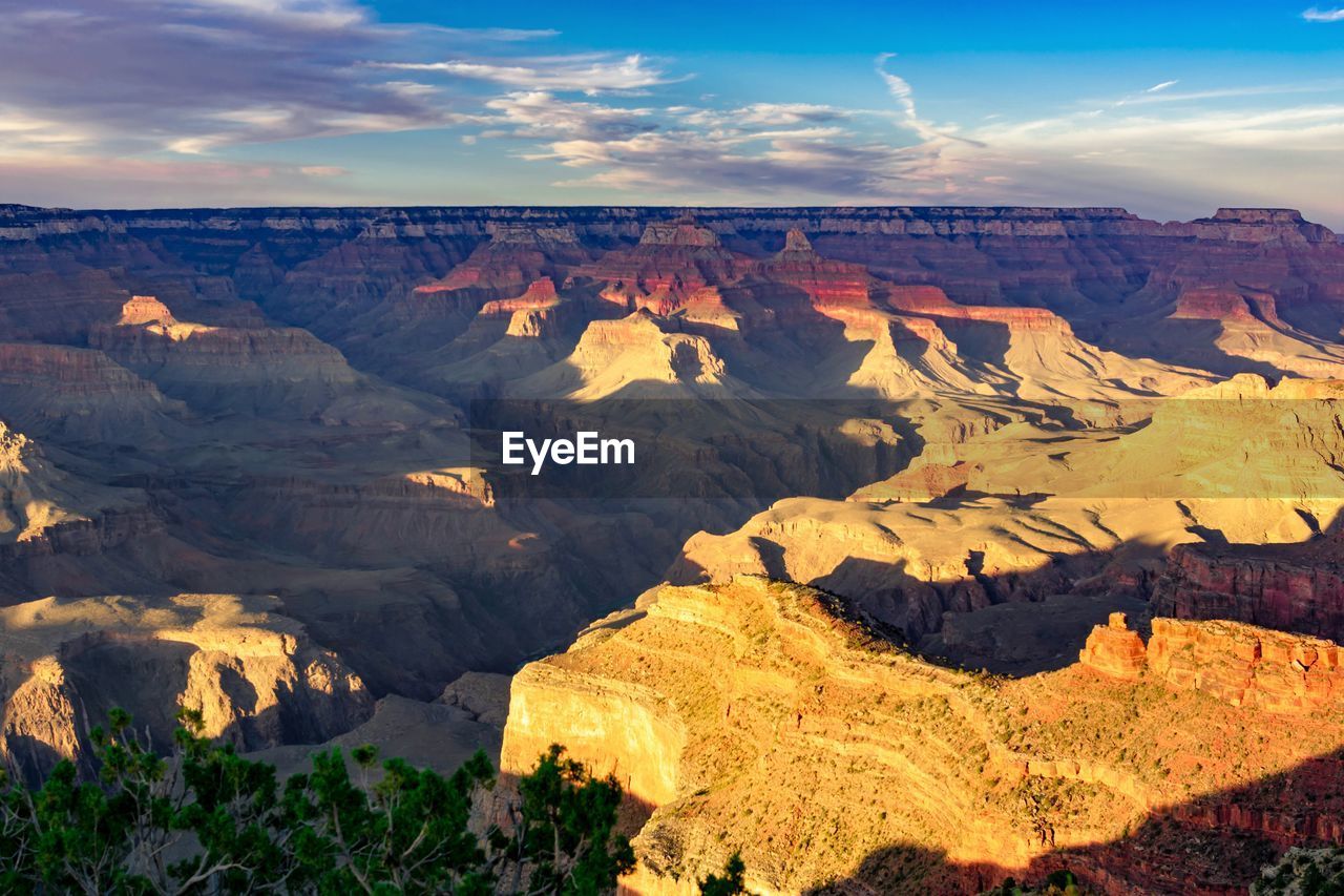 Scenic view of mountains against cloudy sky