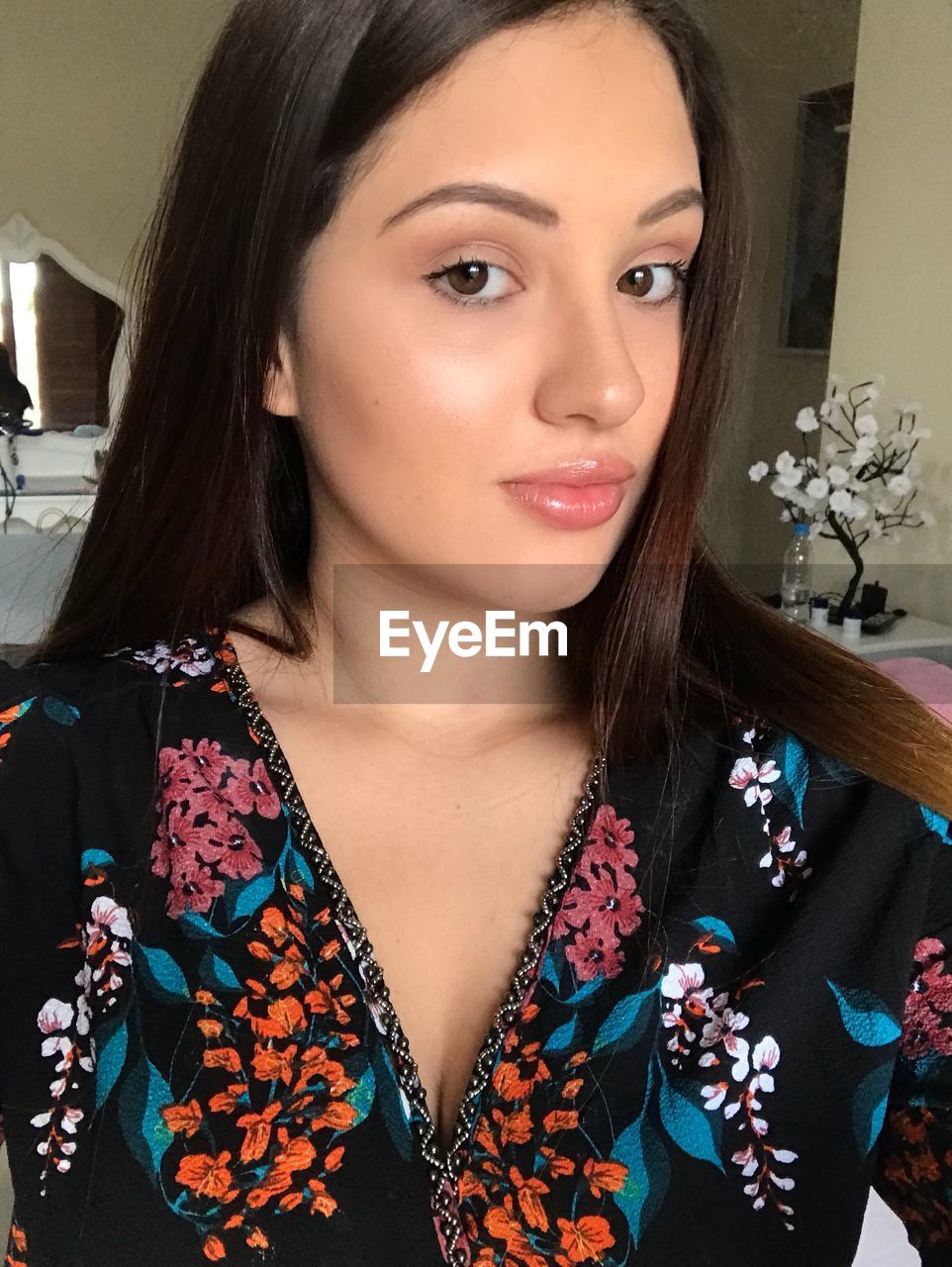 Close-up portrait of young woman at home