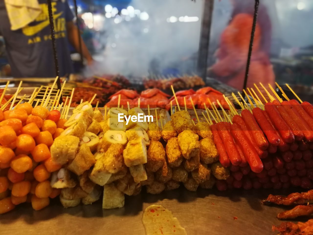 Night market atmosphere with smoky grilled food menu