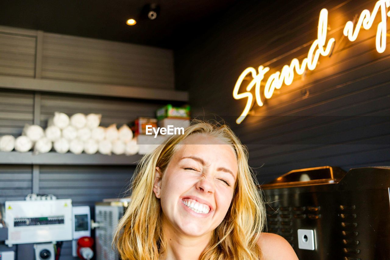 Close-up of happy woman in restaurant