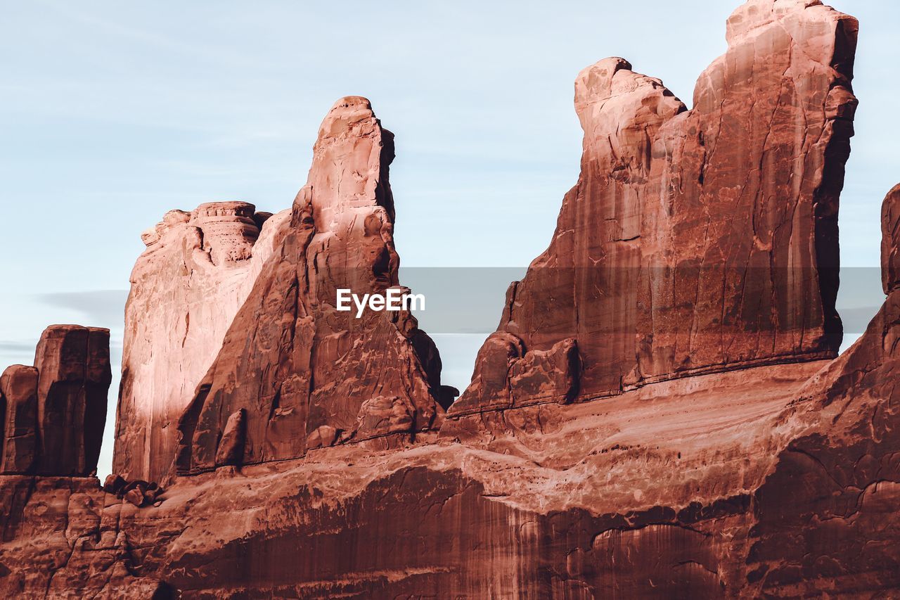 Low angle view of rock formations against sky