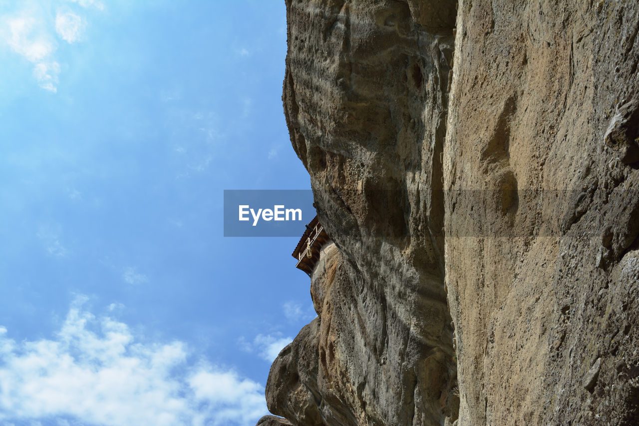 adventure, rock, sky, cloud, low angle view, nature, sports, extreme sports, rock climbing, day, rock formation, climbing, outdoors, mountain, activity, recreation, cliff, blue, no people, individual sports, challenge, beauty in nature, strength