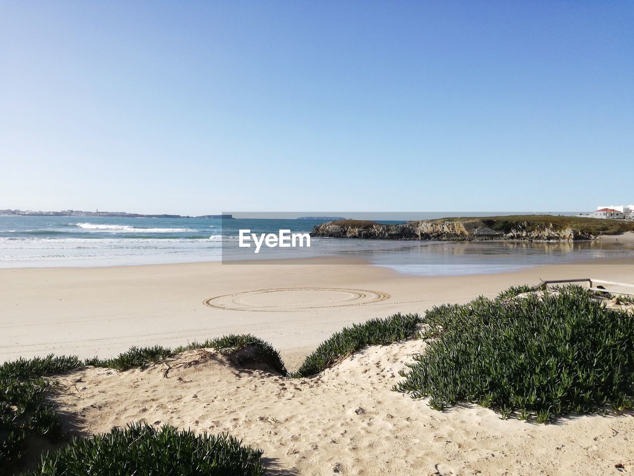 Scenic view of beach against clear sky