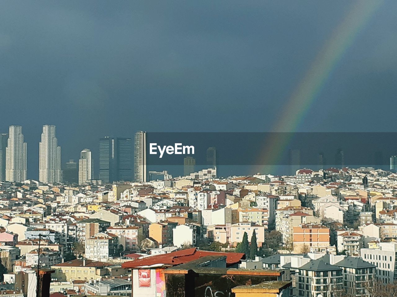 AERIAL VIEW OF RAINBOW OVER BUILDINGS IN CITY