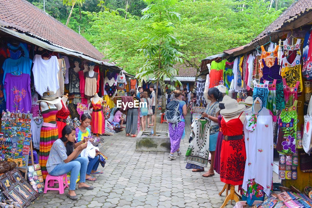 PEOPLE SITTING IN MARKET