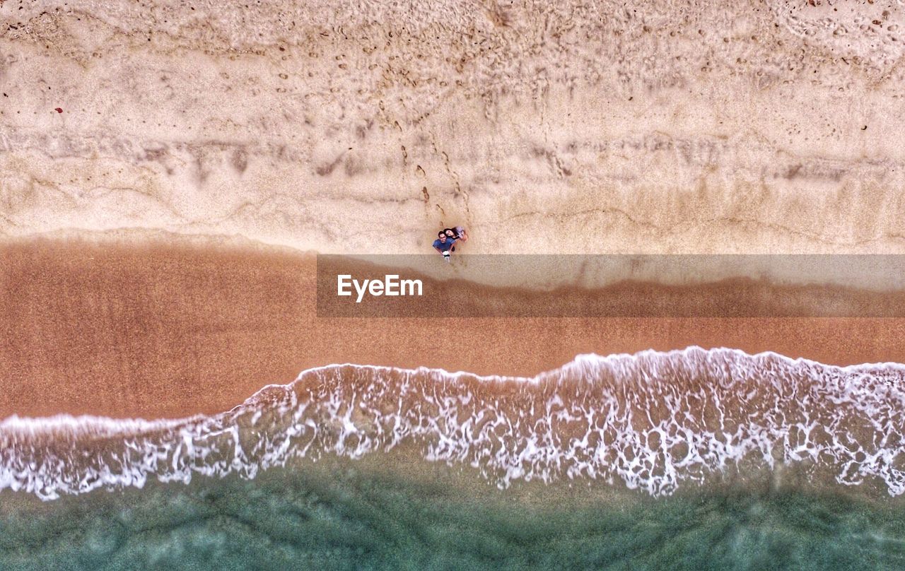 Couple seen from above on beach