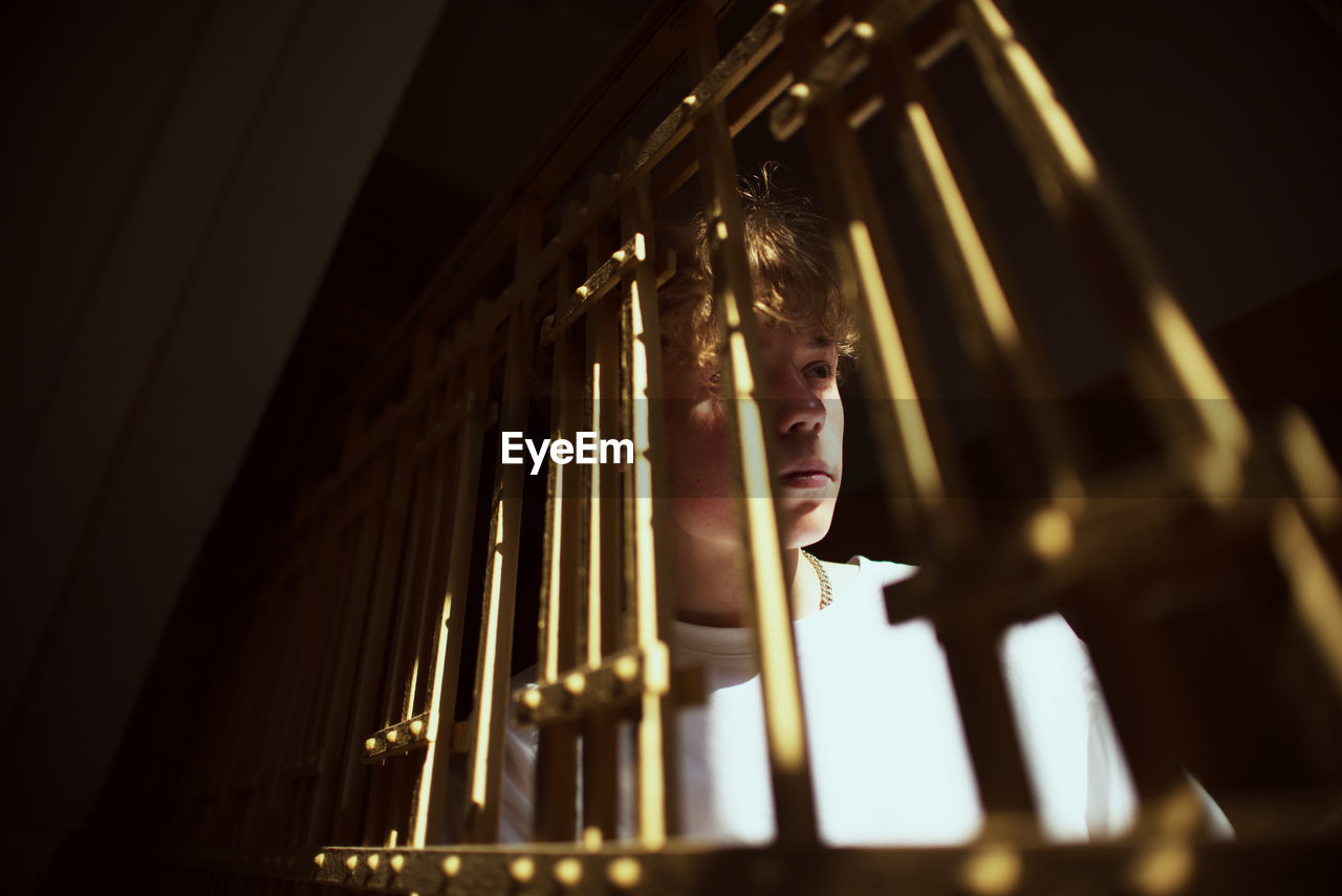 Close-up of teenage boy looking away at home