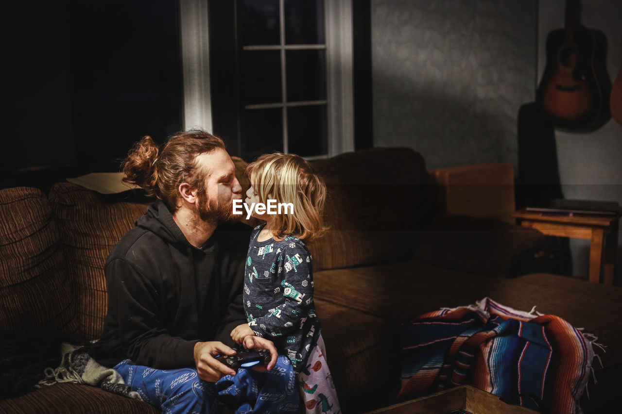 Little boy kissing his dad goodnight