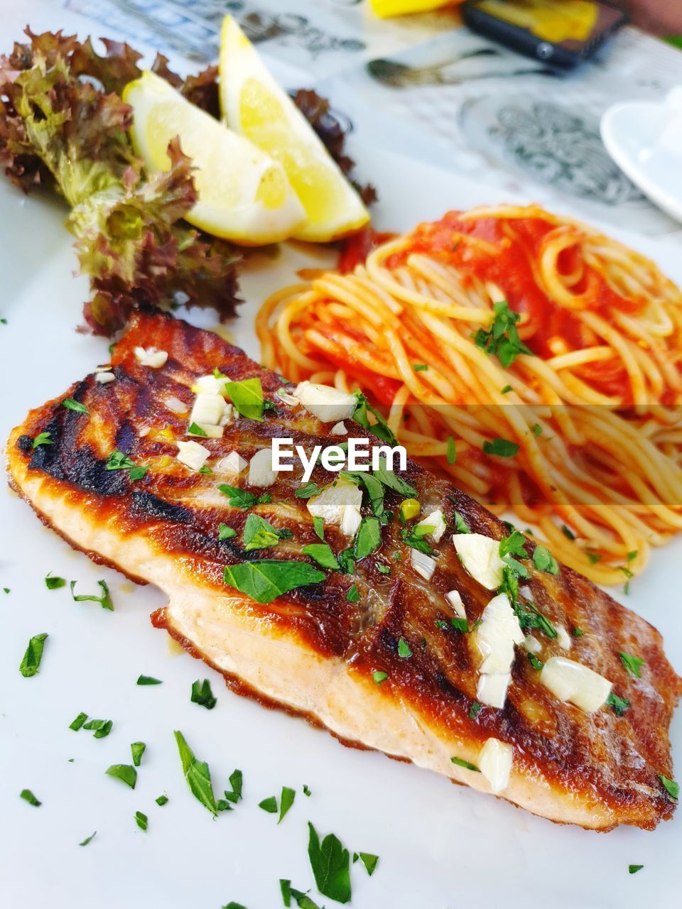 High angle view of salmon with pasta served on table
