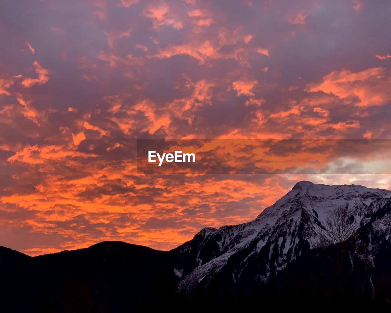 Scenic view of silhouette mountains against sky during sunset