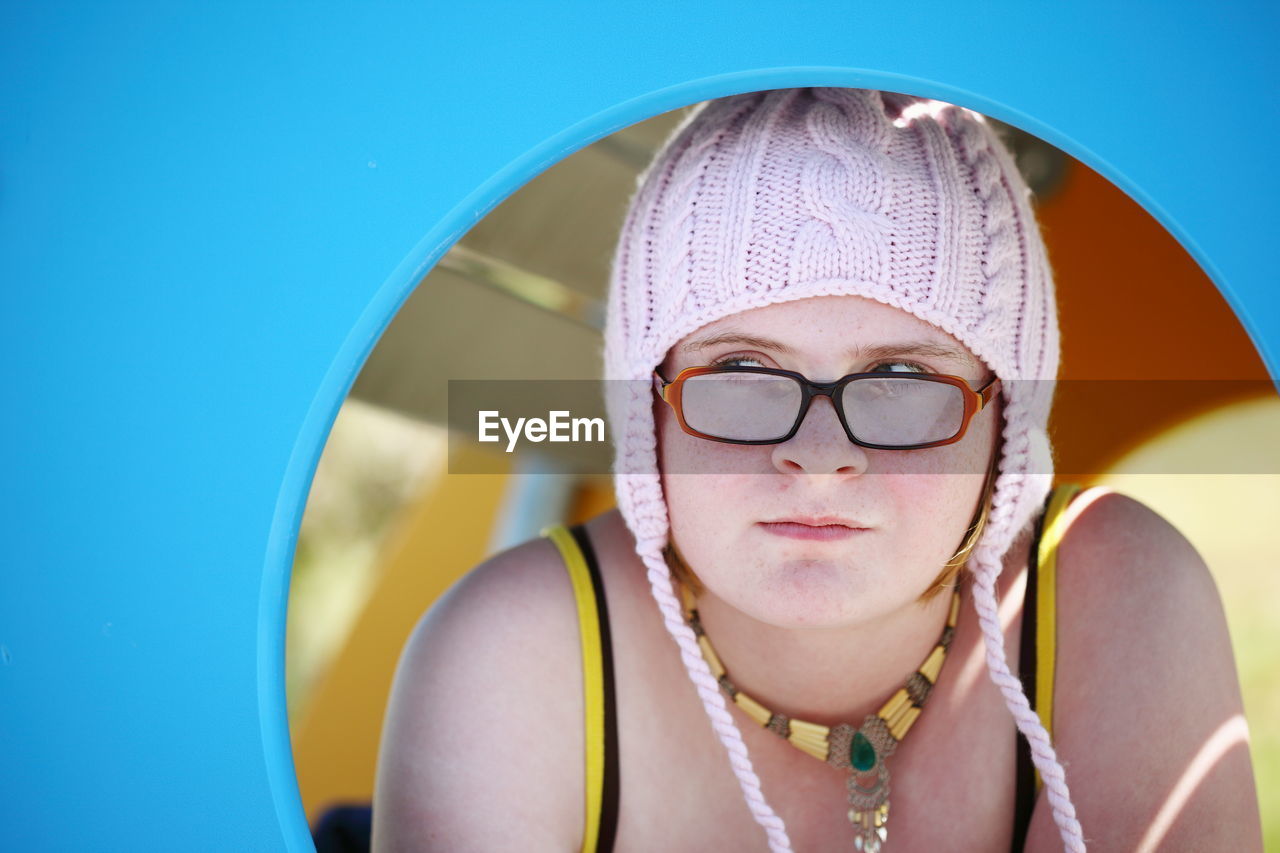 Young woman in knit hat seen through circle