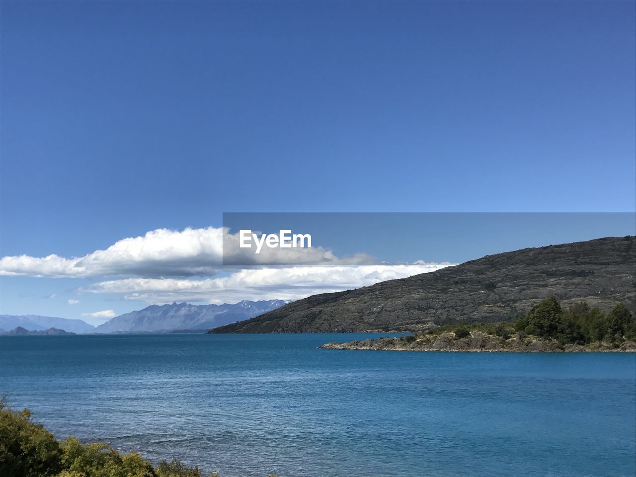 Scenic view of sea against blue sky