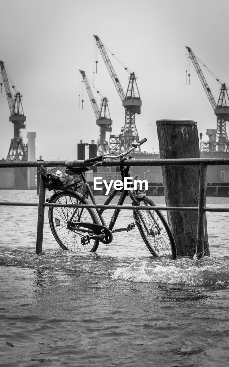 BICYCLE ON PIER AGAINST SEA