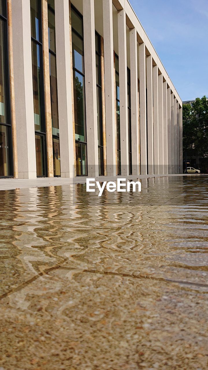 REFLECTION OF BUILDINGS ON WET GLASS